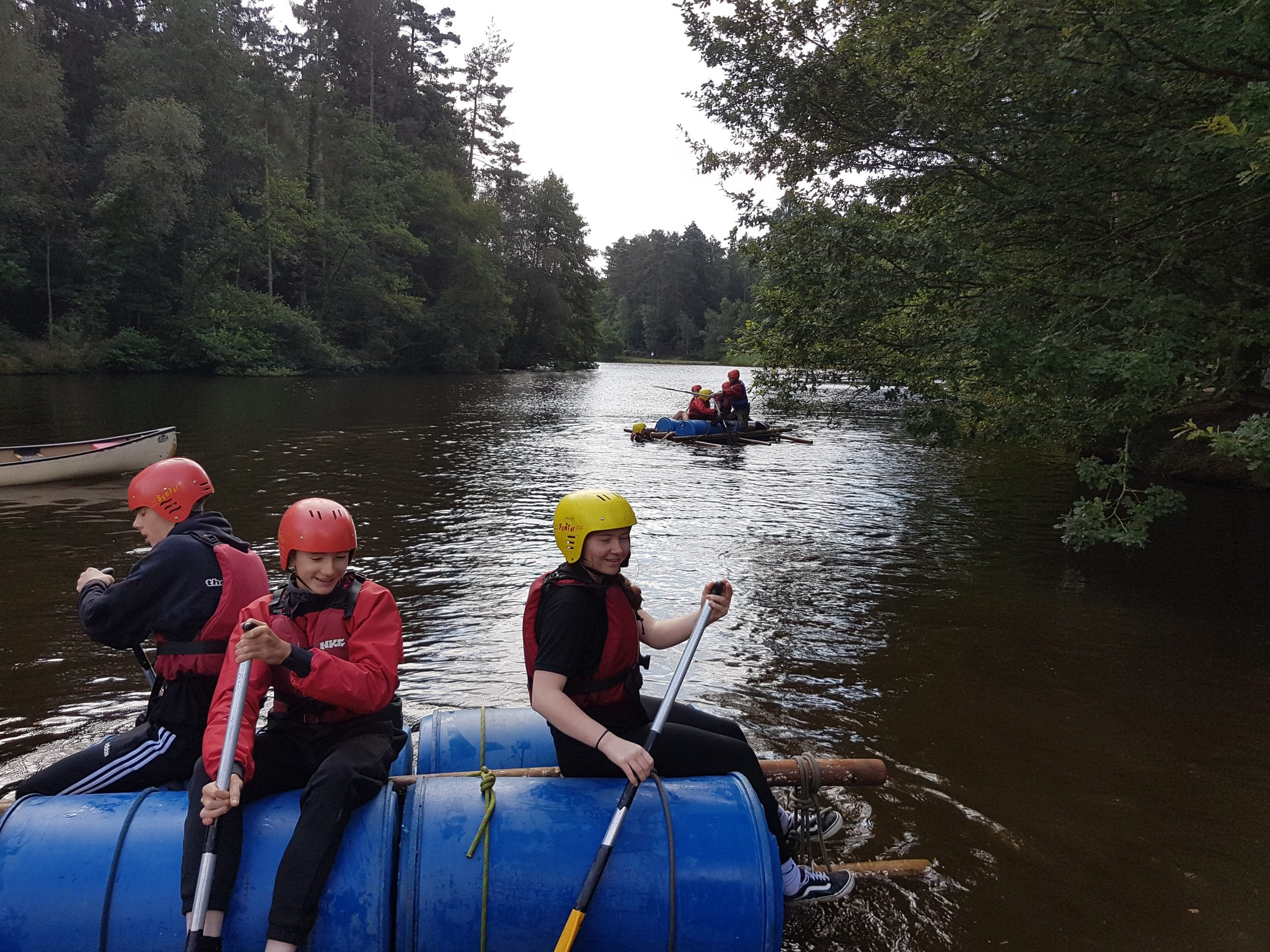 Young people on rafts in the water