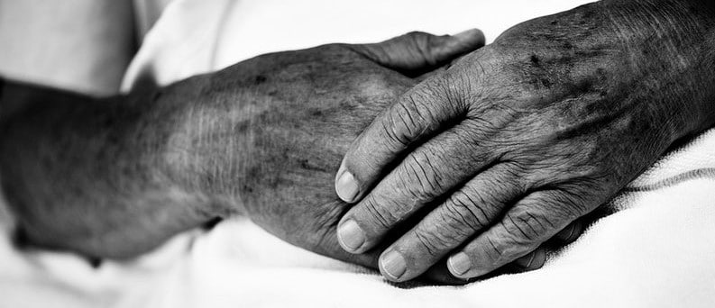 A black and white picture of two hands holding