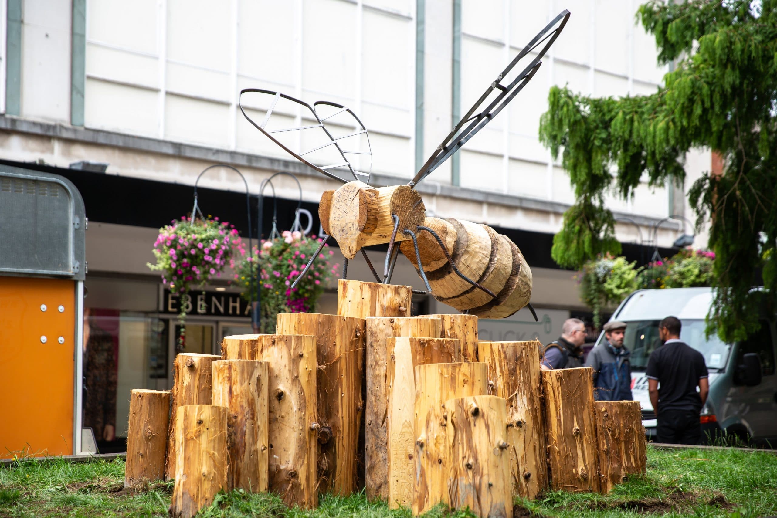 A picture of a large wooden bee with metal wings