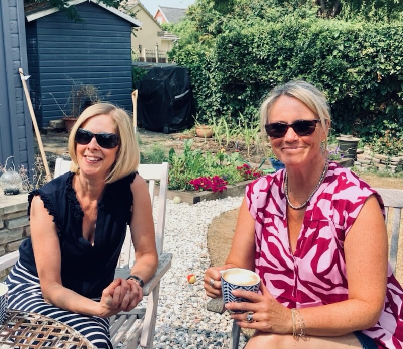 A photo of GCF staff Faye Hennessy and Lucy Pollock sat outside enjoying a coffee break after the call